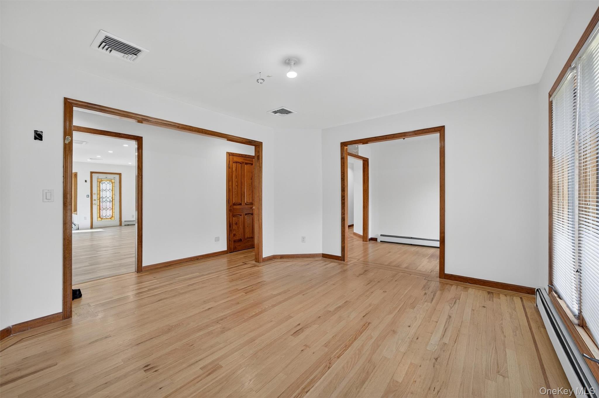 220 Oxford Road Chester, NY 10918 - Photo 18 of 50 a view of an empty room with wooden floor and a window