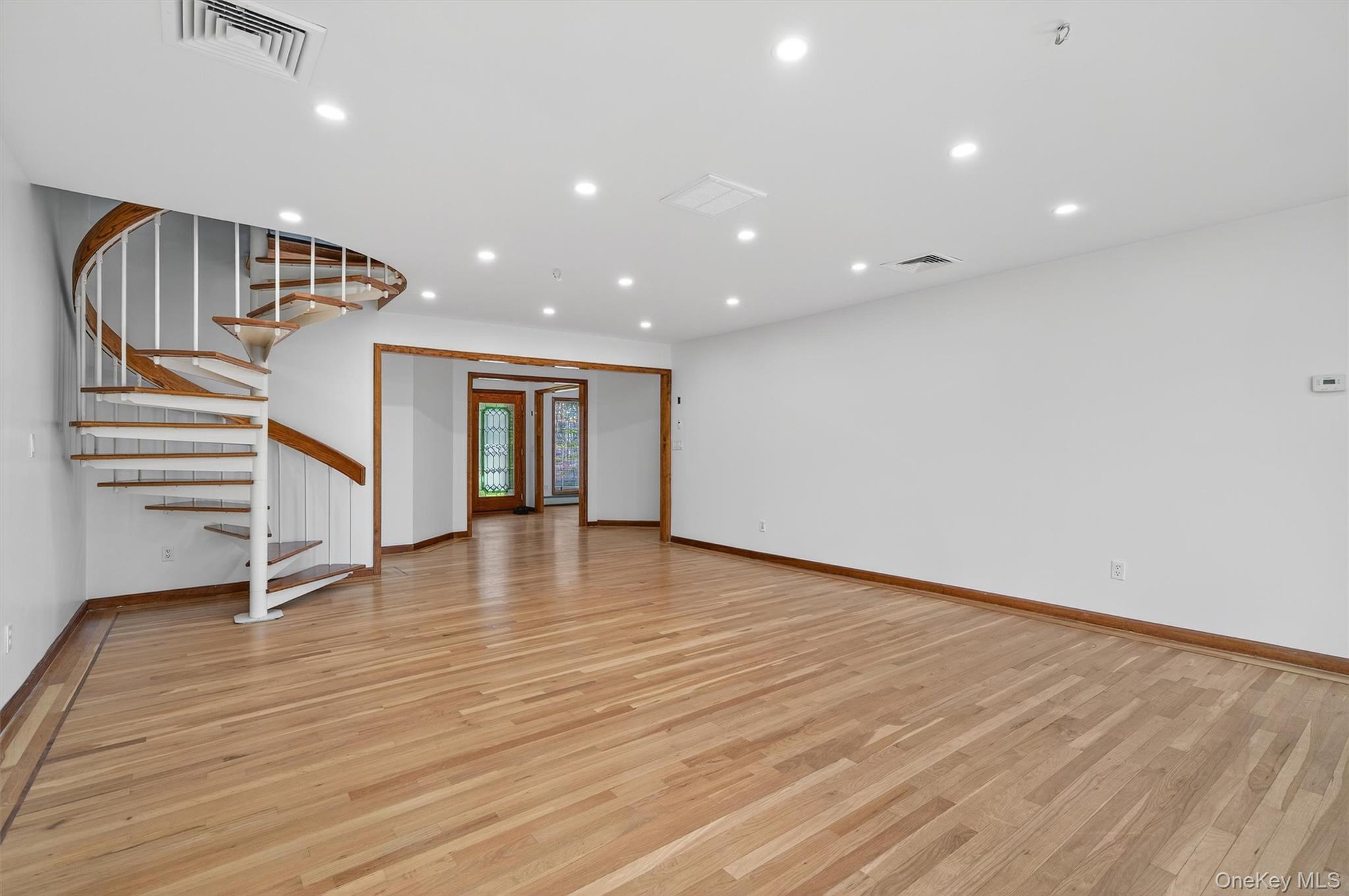 220 Oxford Road Chester, NY 10918 - Photo 22 of 50 a view of an empty room with wooden floor and stairs