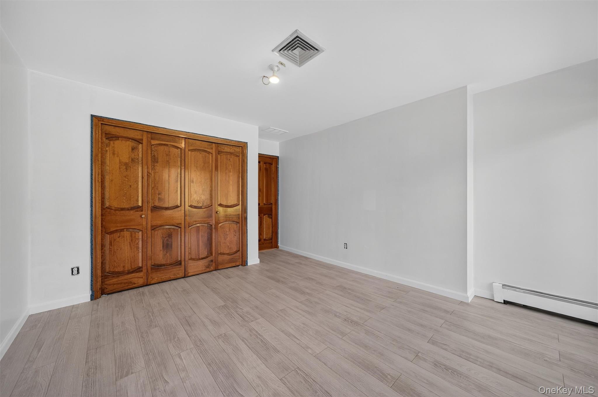 220 Oxford Road Chester, NY 10918 - Photo 33 of 50 a view of an empty room with wooden floor and cabinet