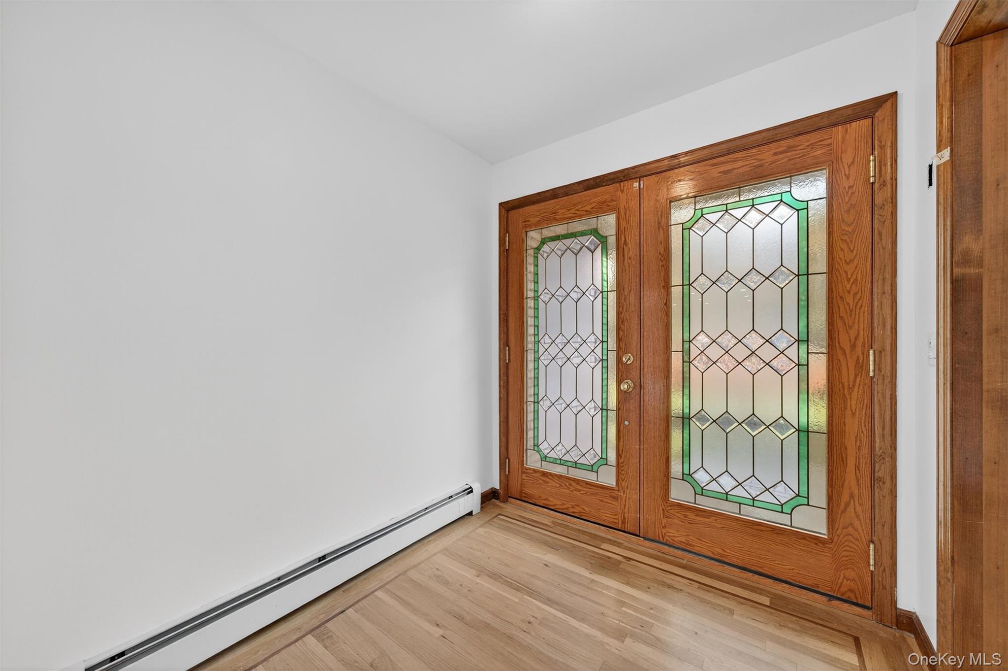 220 Oxford Road Chester, NY 10918 - Photo 5 of 50 an empty room with wooden floor and windows
