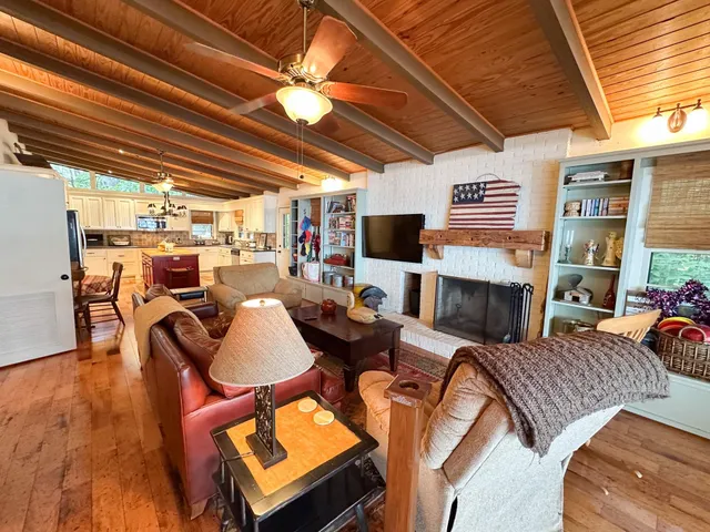 a kitchen with wooden floors and stainless steel appliances