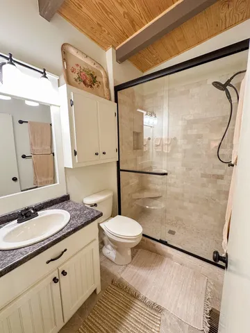 a living room with furniture a ceiling fan and a rug