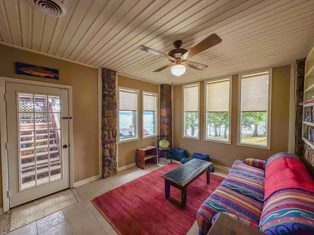 a living room with furniture a rug and a chandelier