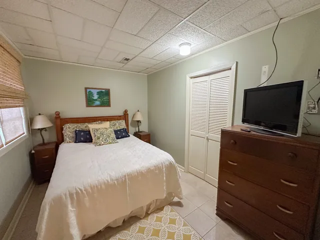 a bedroom with furniture and a rug