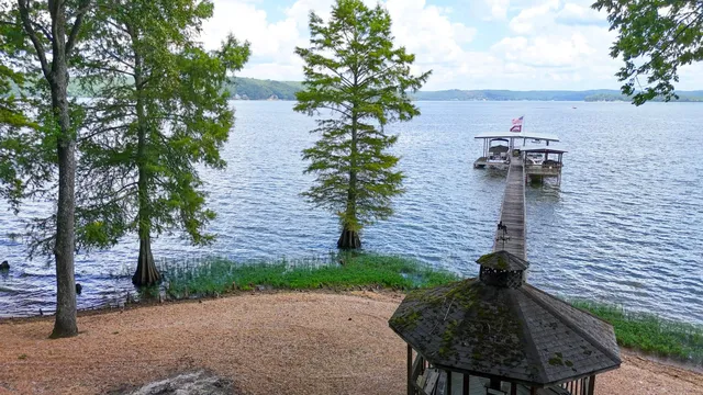 a living room with furniture a flat screen tv and a floor to ceiling window