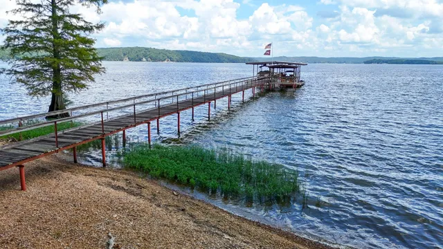 a living room with fireplace furniture and a large window