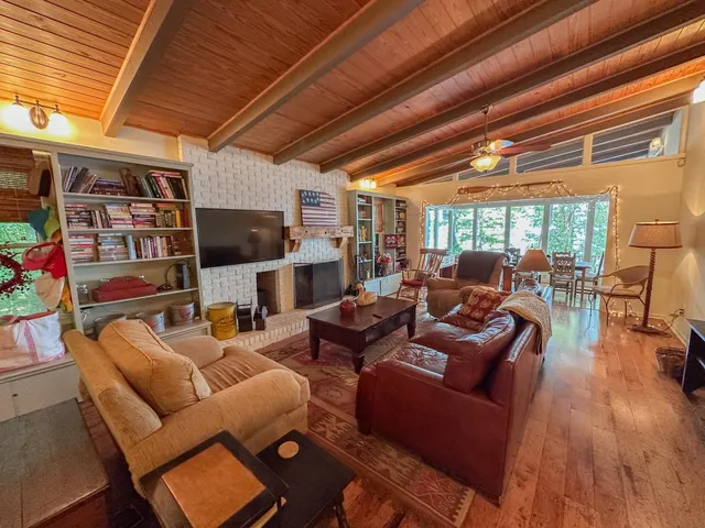 a kitchen with stainless steel appliances granite countertop a stove a refrigerator a sink and dishwasher with wooden floor