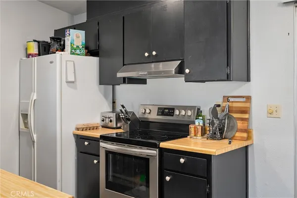 a kitchen with a sink a stove and cabinets