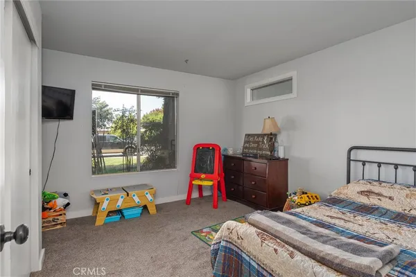 a bedroom with a bed and a tv