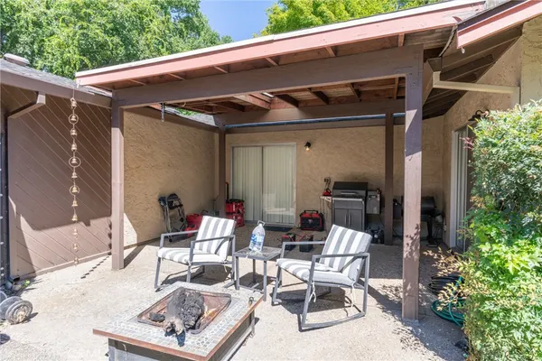 a view of backyard with outdoor seating and plants