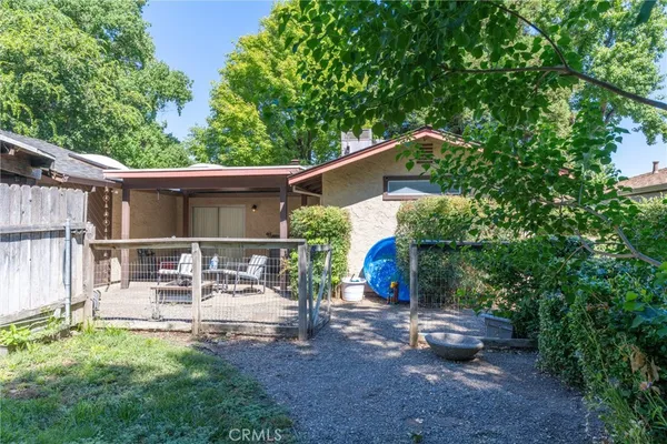 a view of backyard with outdoor seating and plants