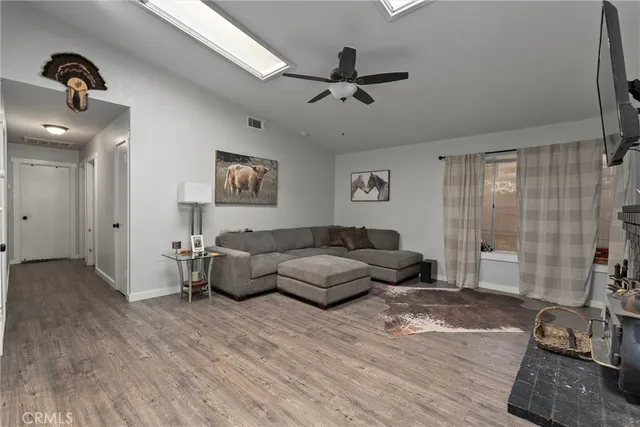 a bathroom with a sink a toilet a mirror and shower curtain