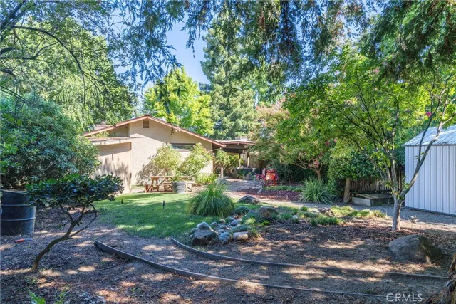 a backyard of a house with table and chairs