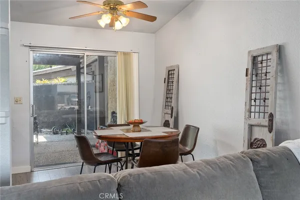 a view of a dining room with furniture and chandelier