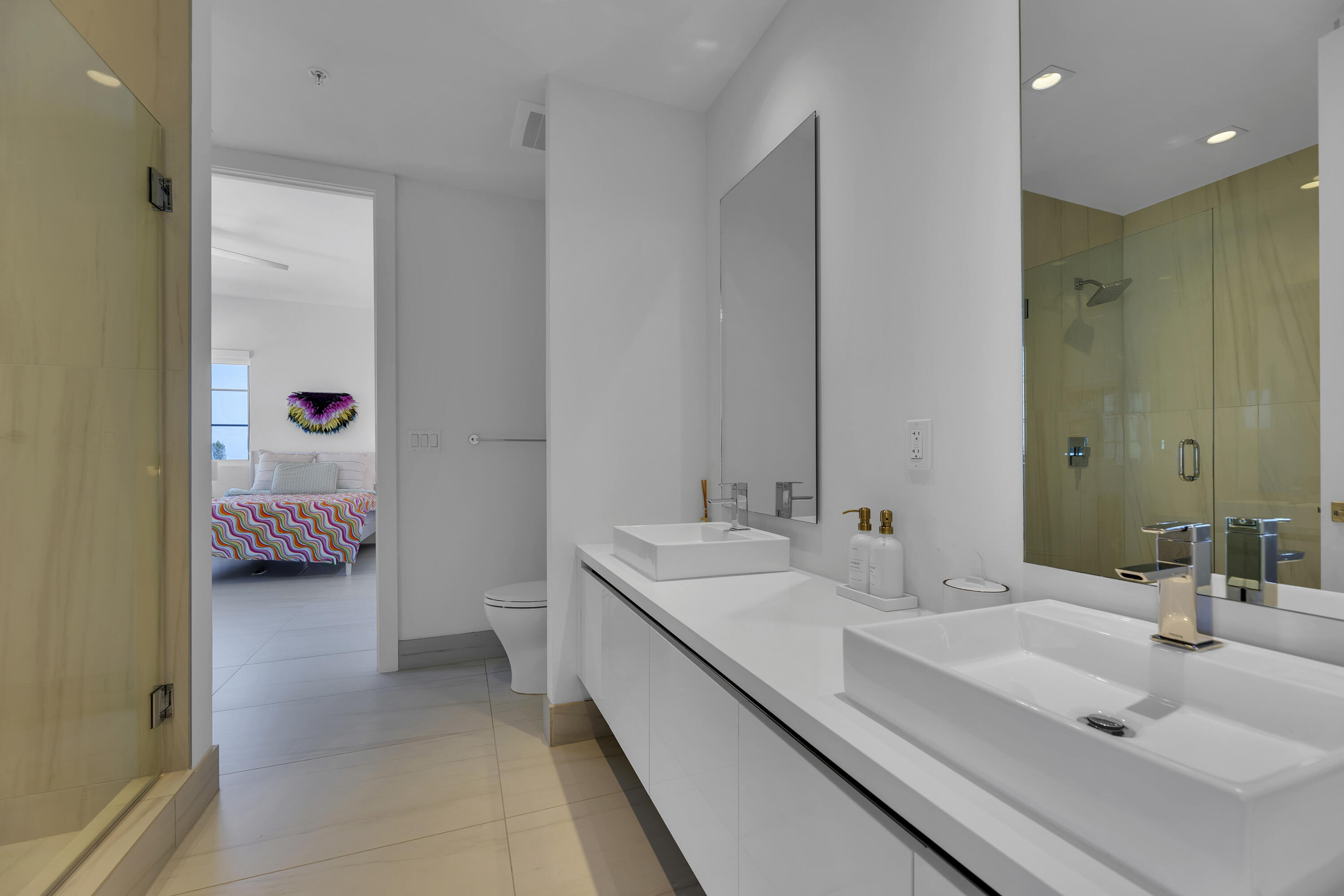 155 East Boca Raton Road, Unit 607 Boca Raton, FL 33432 - Photo 11 of 15 a en suite bathroom with a sink and a mirror