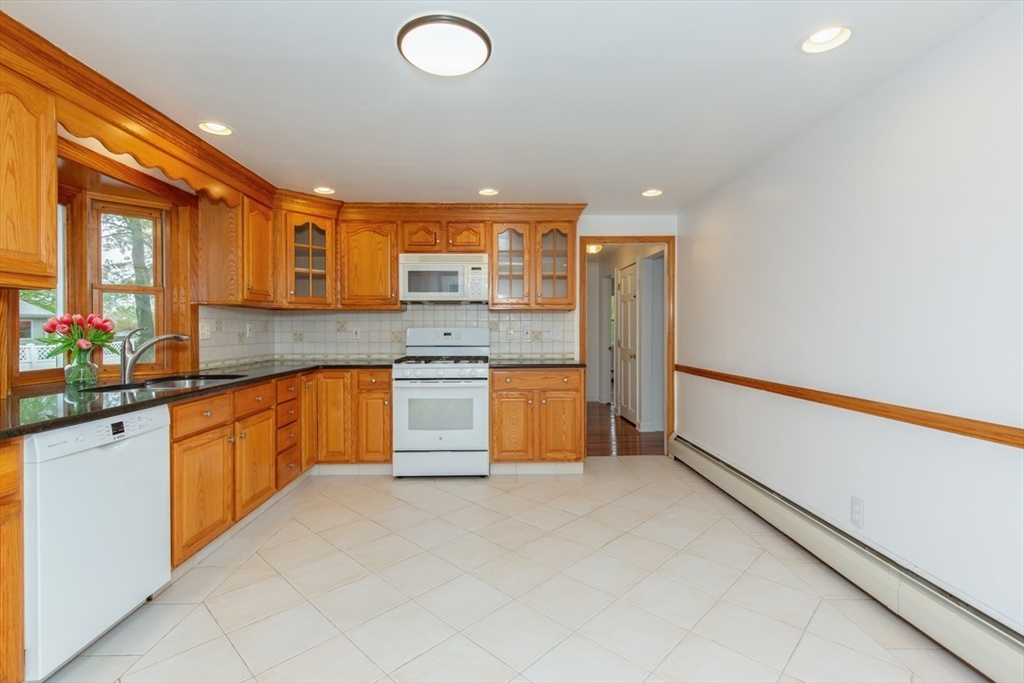 28 McKenney Circle Andover, MA 01810 - Photo 11 of 42 a large kitchen with stainless steel appliances granite countertop a sink and cabinets
