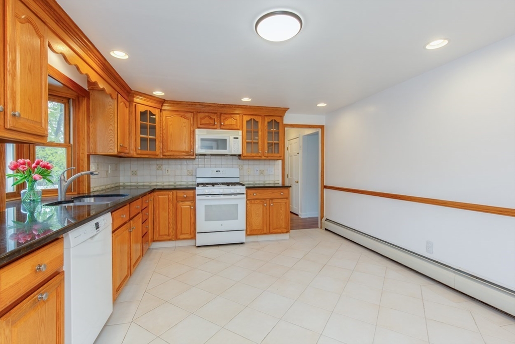 28 McKenney Circle Andover, MA 01810 - Photo 12 of 42 a large kitchen with stainless steel appliances granite countertop a sink and cabinets
