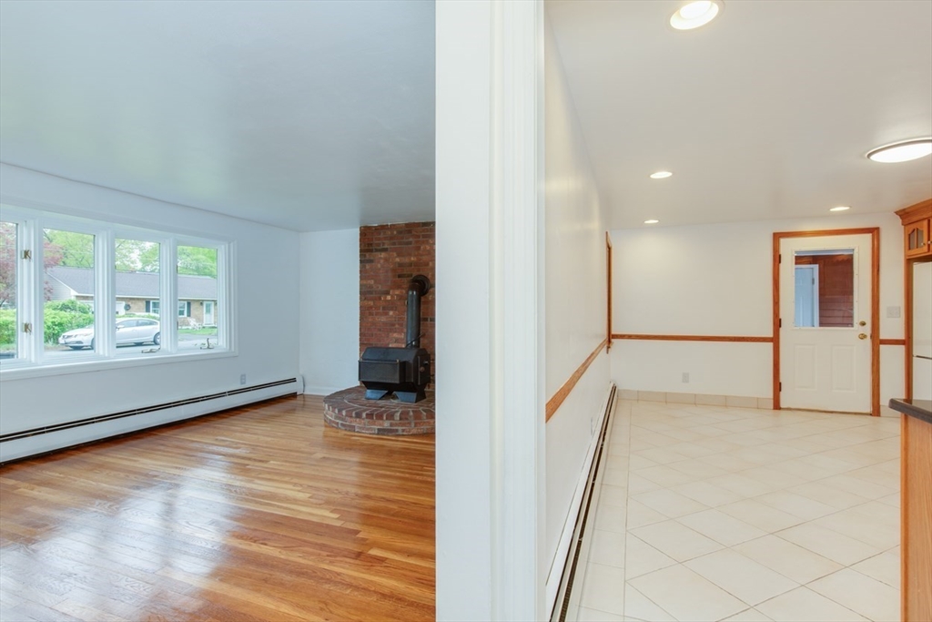 28 McKenney Circle Andover, MA 01810 - Photo 13 of 42 an empty room with wooden floor and windows