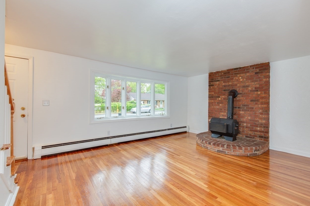 28 McKenney Circle Andover, MA 01810 - Photo 14 of 42 wooden floor in an empty room with a window