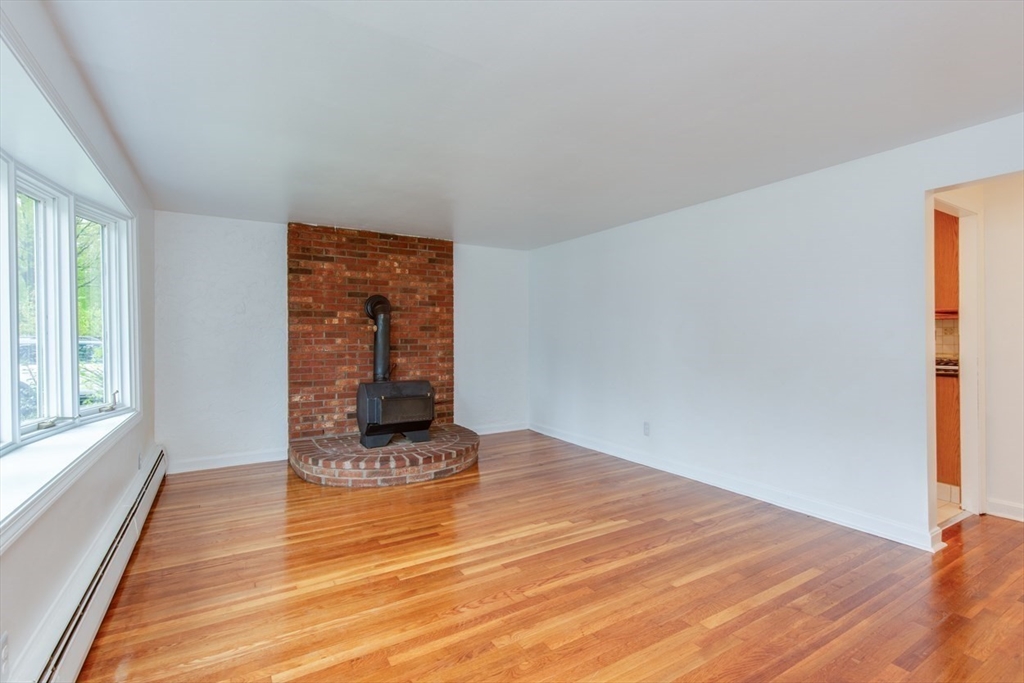 28 McKenney Circle Andover, MA 01810 - Photo 16 of 42 a view of a room that has wooden floor and window in it