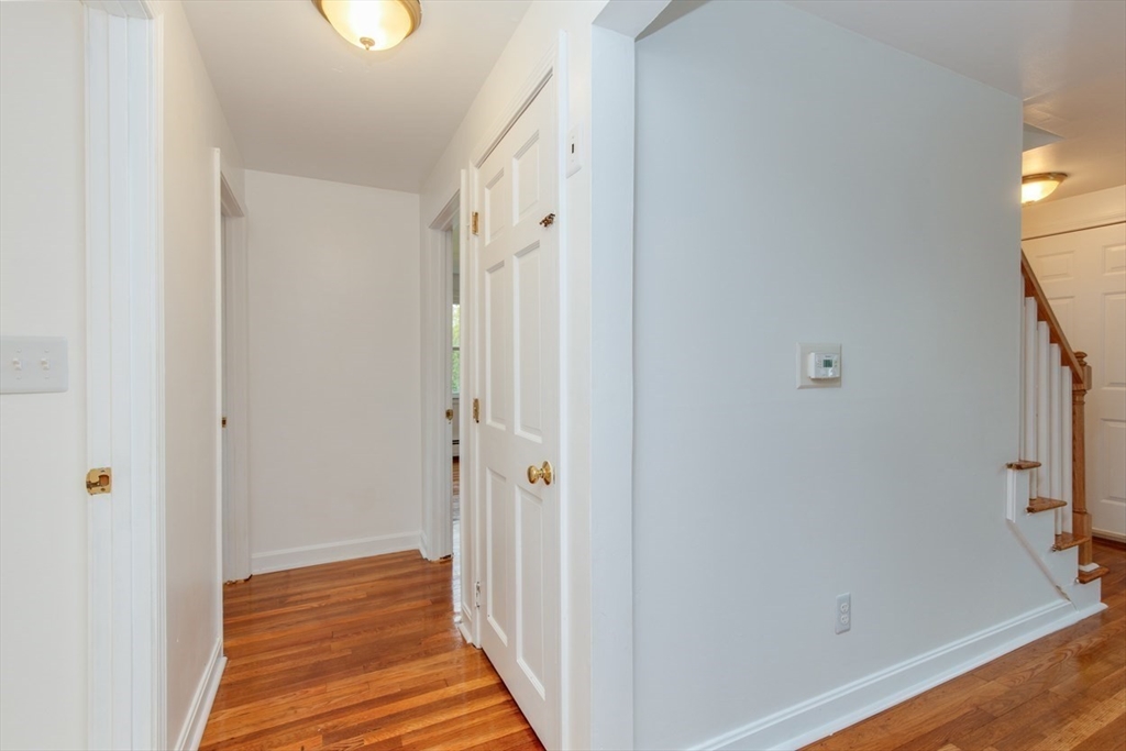 28 McKenney Circle Andover, MA 01810 - Photo 18 of 42 a view of a hallway with wooden floor and staircase