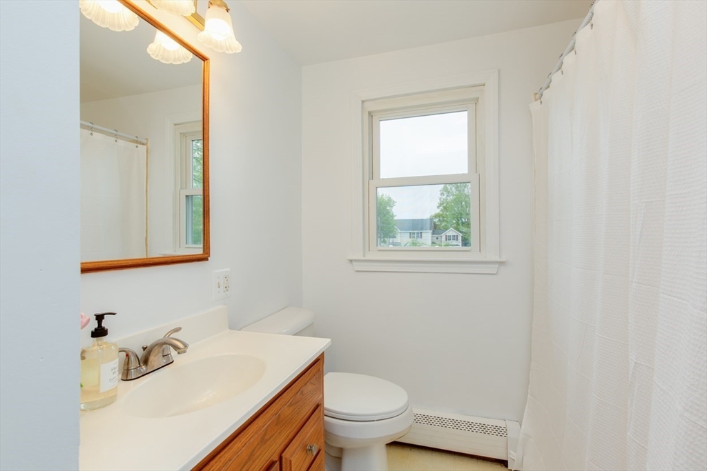28 McKenney Circle Andover, MA 01810 - Photo 19 of 42 a bathroom with a sink a toilet and a window
