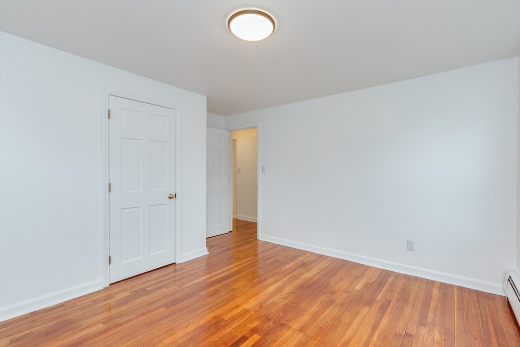 28 McKenney Circle Andover, MA 01810 - Photo 20 of 42 a view of a room with wooden floor and white walls
