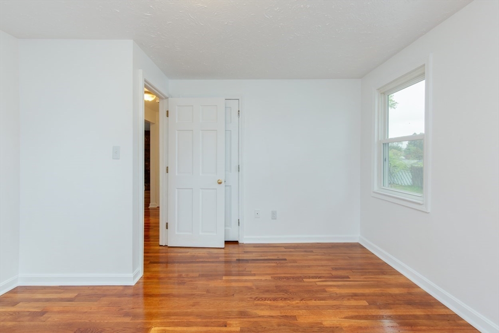 28 McKenney Circle Andover, MA 01810 - Photo 24 of 42 a view of empty room with wooden floor and fan