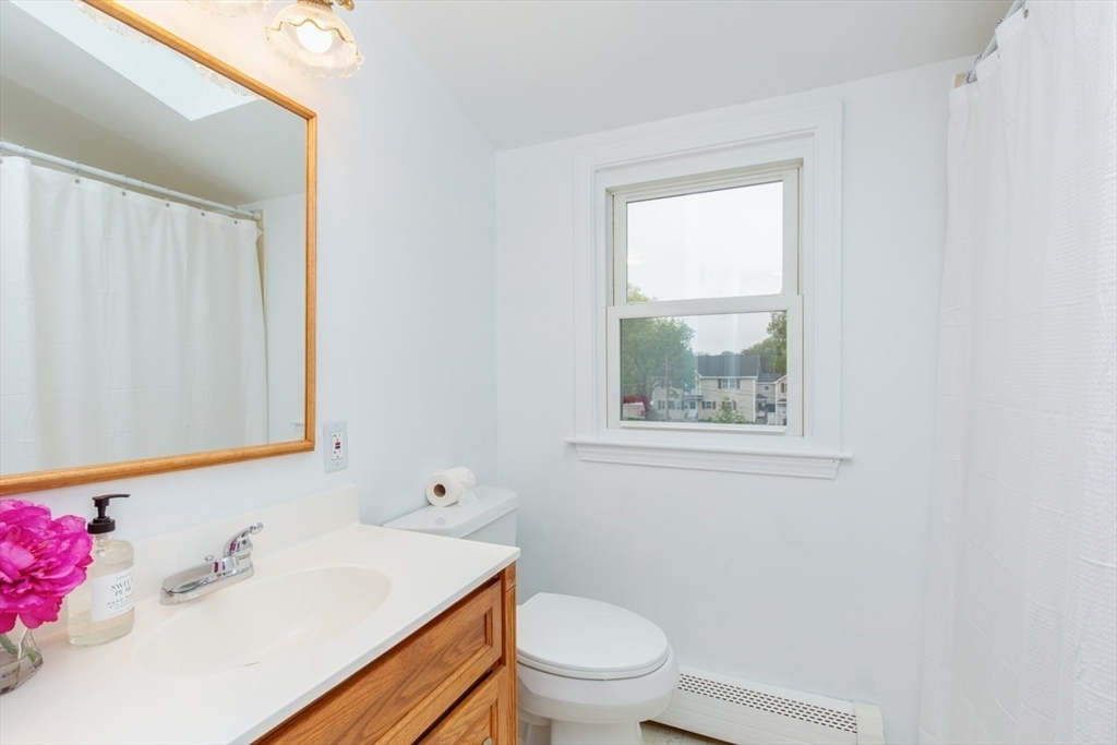 28 McKenney Circle Andover, MA 01810 - Photo 28 of 42 a bathroom with a sink toilet and window