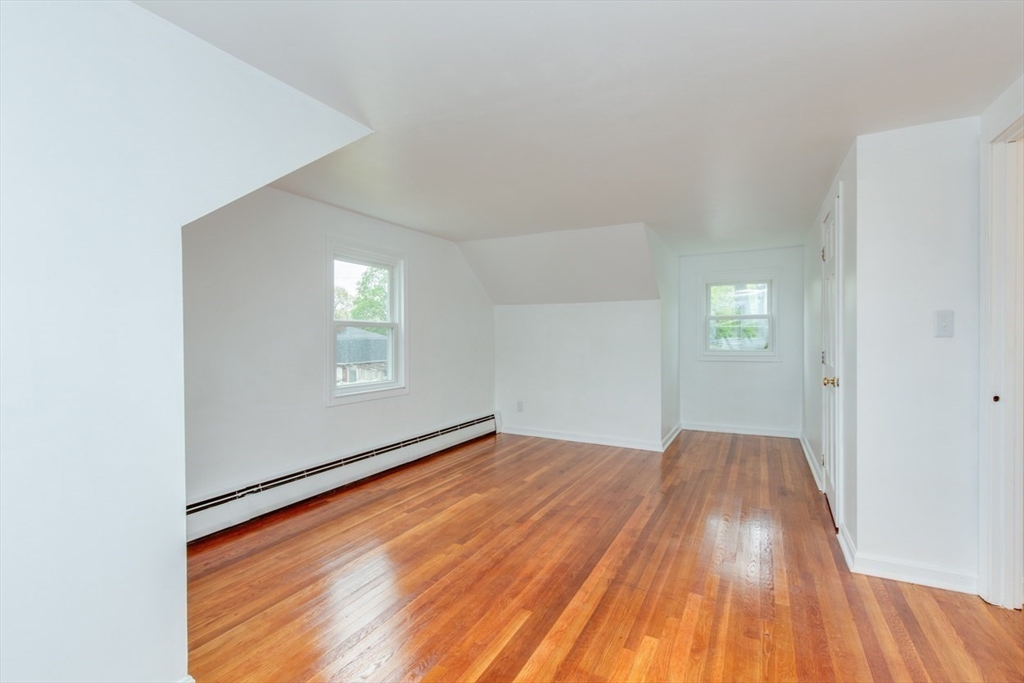 28 McKenney Circle Andover, MA 01810 - Photo 30 of 42 an empty room with wooden floor and windows