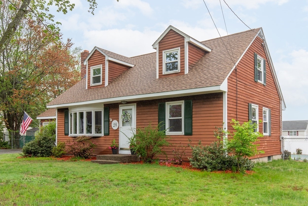 28 McKenney Circle Andover, MA 01810 - Photo 3 of 42 a front view of a house with a yard and potted plants