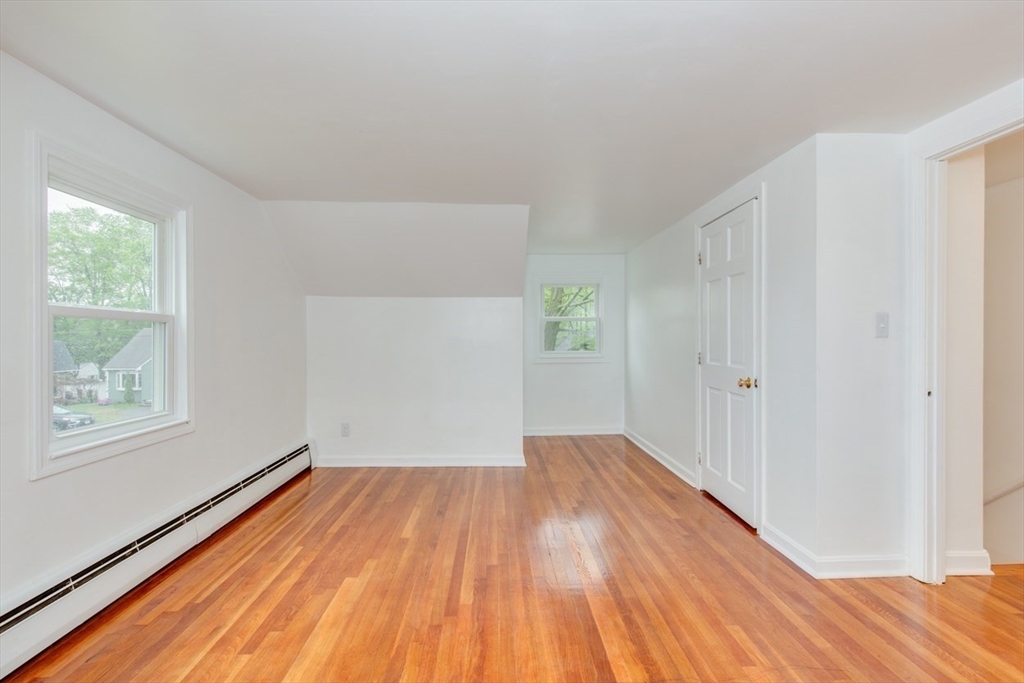 28 McKenney Circle Andover, MA 01810 - Photo 33 of 42 a view of empty room with wooden floor and fan