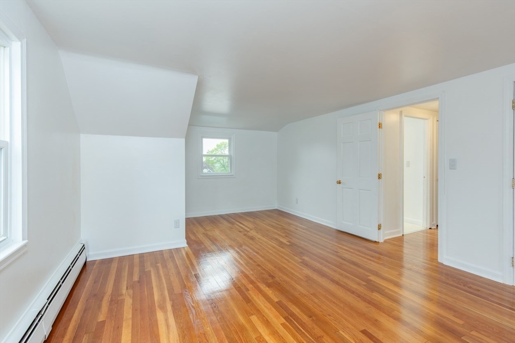 28 McKenney Circle Andover, MA 01810 - Photo 34 of 42 an empty room with wooden floor and windows