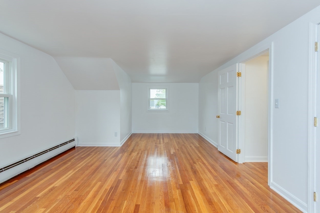 28 McKenney Circle Andover, MA 01810 - Photo 35 of 42 an empty room with wooden floor and windows