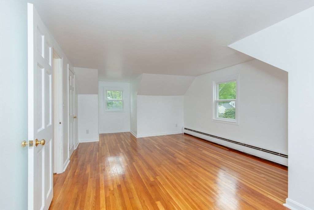 28 McKenney Circle Andover, MA 01810 - Photo 36 of 42 a view of an empty room with wooden floor and a window