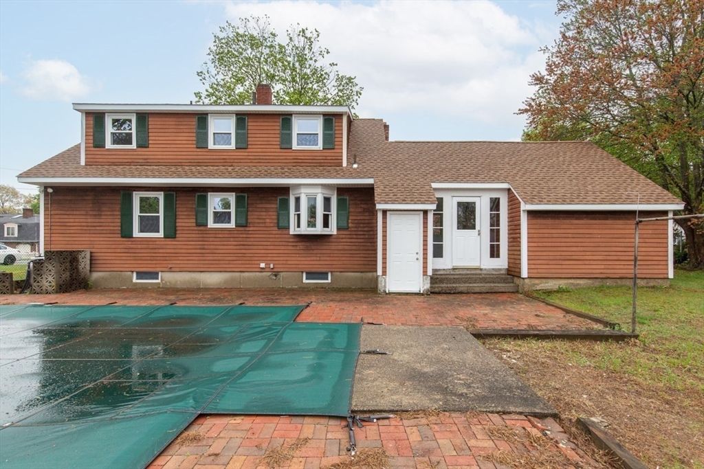28 McKenney Circle Andover, MA 01810 - Photo 39 of 42 a view of a yard in front of a brick house with a large windows