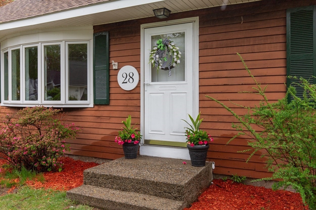 28 McKenney Circle Andover, MA 01810 - Photo 4 of 42 a view of a door of the house with a potted plant