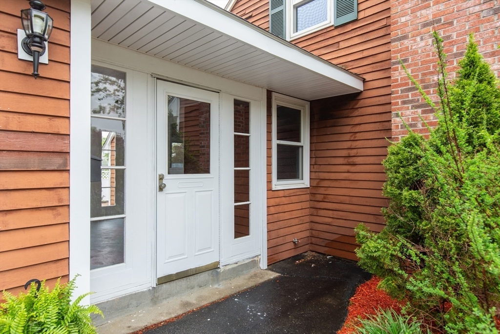28 McKenney Circle Andover, MA 01810 - Photo 5 of 42 a view of house with potted plants