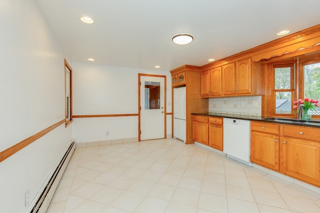 28 McKenney Circle Andover, MA 01810 - Photo 8 of 42 a kitchen with granite countertop a refrigerator and cabinets
