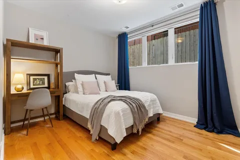 a bedroom with a bed chair and a window