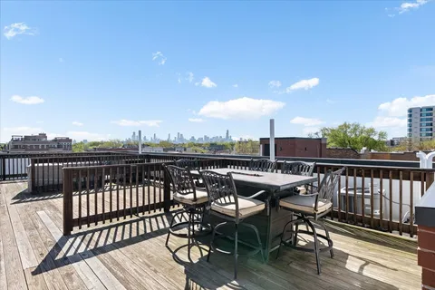 a view of a balcony with wooden benches