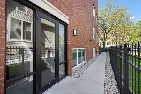a view of a house with brick walls