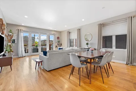 a view of a dining room with furniture and wooden floor