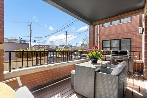 a view of a balcony dining table and chairs