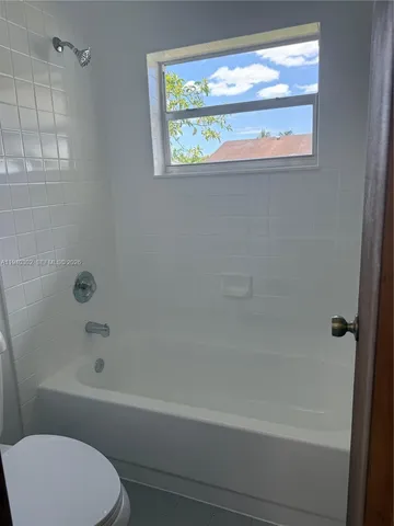 a bathroom with a bathtub and a toilet