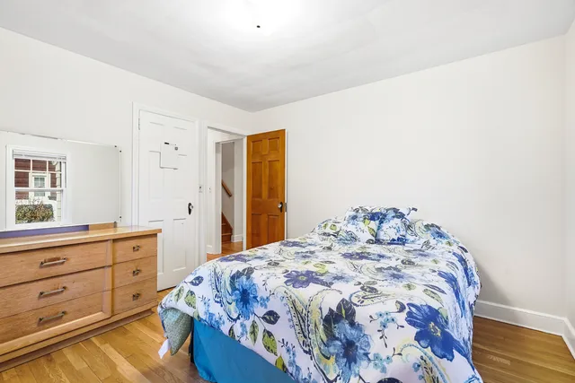 a bedroom with a bed and a dresser in it