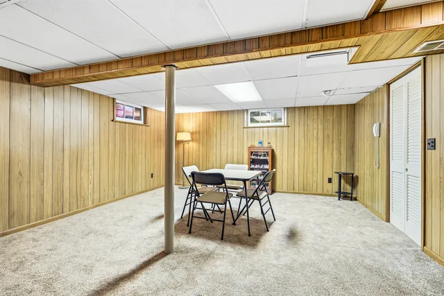 a dining room with furniture and a window
