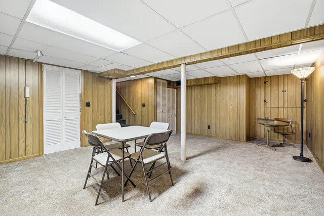 a view of a room that has a table and chairs in it