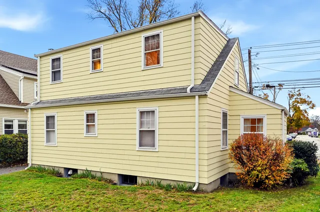 a view of a house with a yard and a garage
