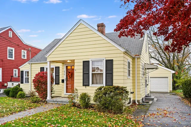 a view of a house with a yard and sitting area